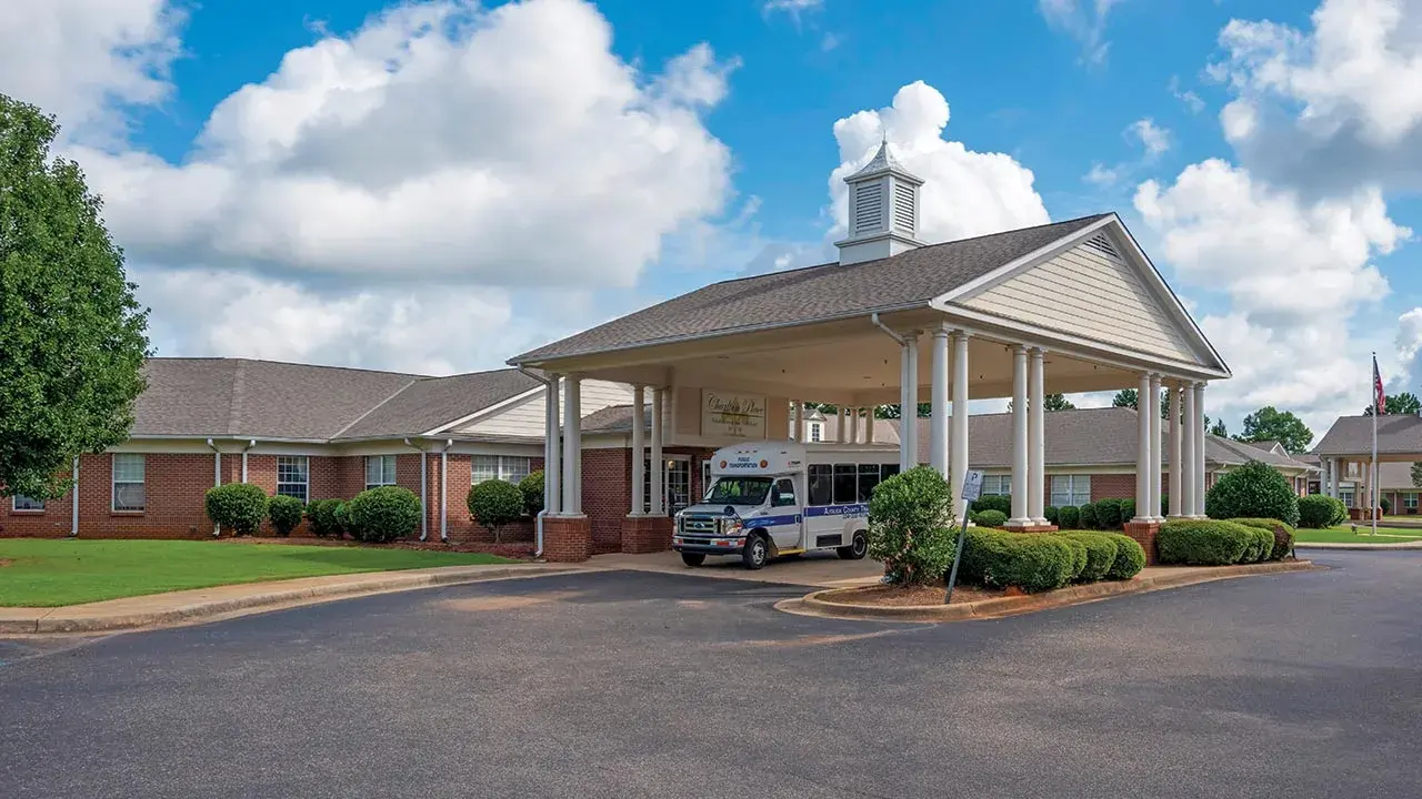 Warm, residential-style medical center with a shaded porch at Charlton Place Rehabilitation &amp; Health Care Center in Deatsville, AL, Elmore County.