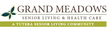 Logo of Grand Meadows Senior Living & HEALTH CARE - A TUTERA SENIOR LIVING COMMUNITY. A green and white stylized leaf icon is on the left side.