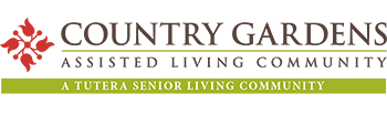 Logo of Country Gardens Assisted Living Community, featuring a red rooftop graphic on the left, text in brown and green, and the tagline 