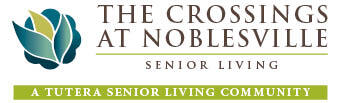 Logo for The Crossings at Noblesville Senior Living, featuring a stylized leaf design and text reading 
