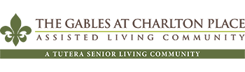 Logo of The Gables at Charlton Place Assisted Living. Below is the text 'A Tutera Senior Living Community' in dark brown on a green background.