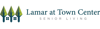 Logo for Lamar at Town Center Senior Living. It features stylized green trees with blue trunks resembling houses, followed by the text 